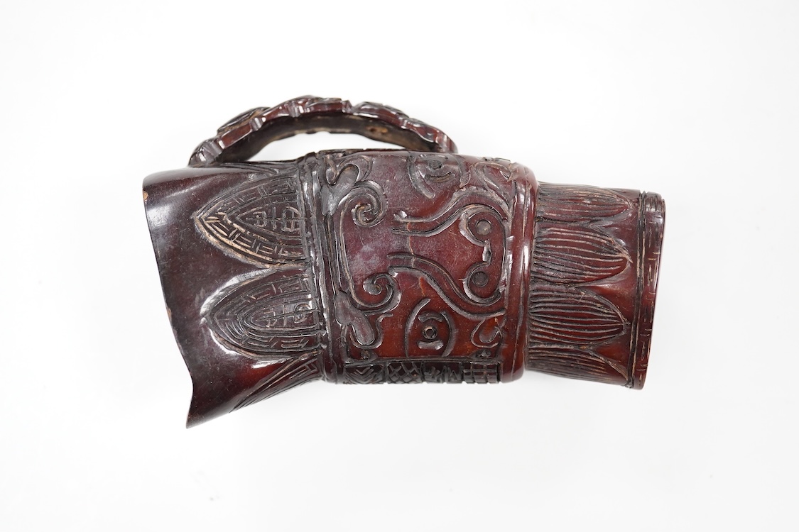 A Chinese carved horn jug, 11cm high